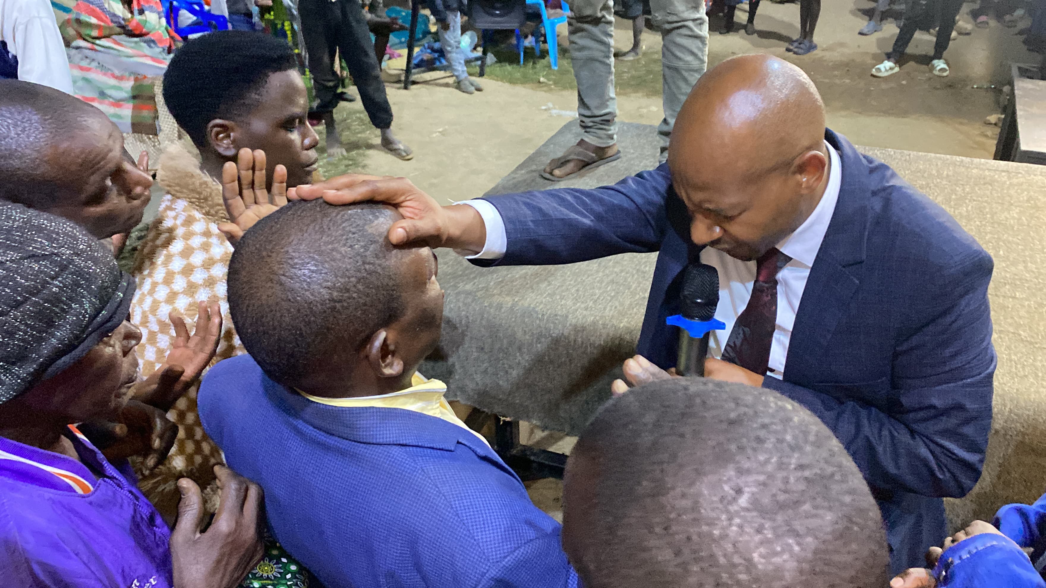 Pastor Gerald praying for the congregation