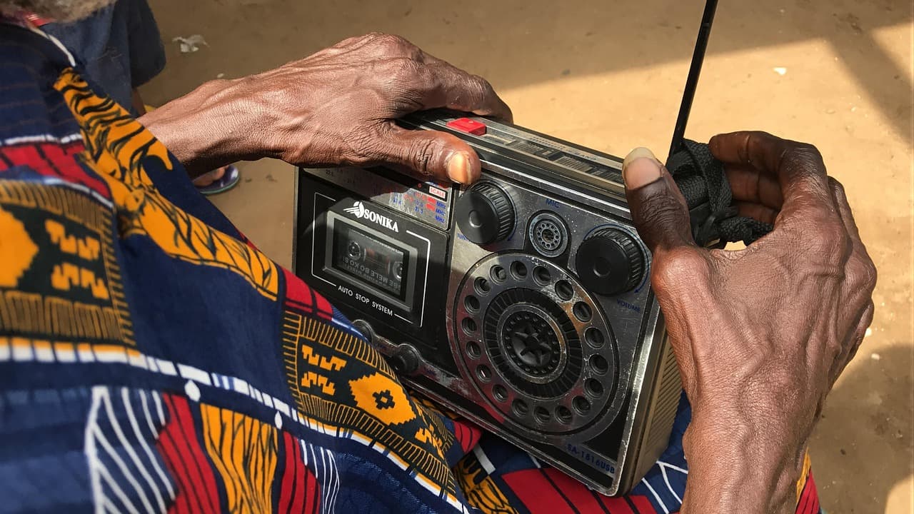 man listening to a radio