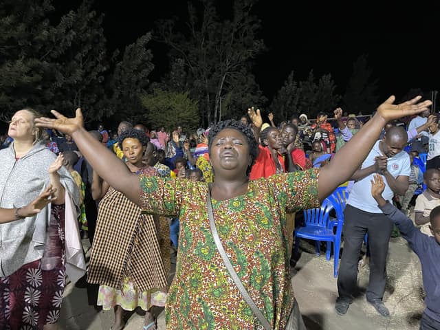 A woman at a revival gathering